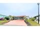 Charming single-story home with a carport and landscaped front yard at 6642 Acacia Ct, North Port, FL 34287