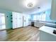 Bright eat-in kitchen features updated white cabinetry, wood flooring, stainless appliances, and lots of natural light at 6642 Acacia Ct, North Port, FL 34287