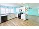 Bright kitchen features stainless appliances, granite counters, and white shaker cabinets at 6642 Acacia Ct, North Port, FL 34287
