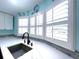 Close up of the kitchen window with modern granite counters and a stainless steel sink at 6642 Acacia Ct, North Port, FL 34287