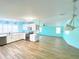 View of the kitchen into an open floor plan with wood floors and shaker cabinets at 6642 Acacia Ct, North Port, FL 34287