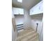 A tidy laundry room with overhead cabinets, shelving, and modern flooring at 6642 Acacia Ct, North Port, FL 34287