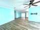 View of the spacious living room with wood floors and backyard access at 6642 Acacia Ct, North Port, FL 34287