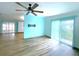 Living room with a ceiling fan and sliding glass door to the backyard at 6642 Acacia Ct, North Port, FL 34287