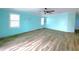 Living room features wood-style floors, a ceiling fan, and windows with blinds at 6642 Acacia Ct, North Port, FL 34287