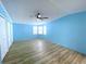 Bedroom features natural light, wood-look floors, and a ceiling fan at 6642 Acacia Ct, North Port, FL 34287