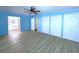 Spacious bedroom with hardwood floors, three closets, and access to the bathroom at 6642 Acacia Ct, North Port, FL 34287