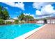 A community pool offers a refreshing oasis for residents with ample lounge chairs and shade at 6642 Acacia Ct, North Port, FL 34287