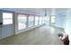 The bright sunroom is filled with natural light and has neutral tile floors at 6642 Acacia Ct, North Port, FL 34287