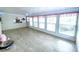 The bright sunroom is filled with natural light and has neutral tile floors at 6642 Acacia Ct, North Port, FL 34287