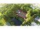Aerial view of community tennis courts next to a serene pond surrounded by lush trees at 6642 Acacia Ct, North Port, FL 34287