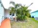 Lawn features a mature palm tree outside of the mobile home at 6642 Acacia Ct, North Port, FL 34287