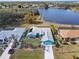 Aerial view of a blue single-story home with an attached garage on a lakefront property at 2275 Kenya Ln, Punta Gorda, FL 33983