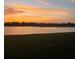 Scenic backyard view features the lake and sunset, offering a tranquil outdoor setting at 2275 Kenya Ln, Punta Gorda, FL 33983