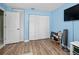 Bright bedroom with wood floors, closet, and blue walls, creating a calm and inviting space at 2275 Kenya Ln, Punta Gorda, FL 33983