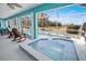 Inviting hot tub on the screened-in patio with a view of the lush landscape at 2275 Kenya Ln, Punta Gorda, FL 33983