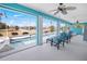 Enclosed lanai with a pool, comfortable seating, and beautiful views of the lake and surrounding greenery at 2275 Kenya Ln, Punta Gorda, FL 33983