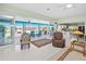 Open-concept living area with sliding glass doors to a screened lanai and a stunning view of the lake at 2275 Kenya Ln, Punta Gorda, FL 33983