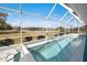 Screened-in pool overlooking a peaceful lake offers a serene backyard oasis at 2275 Kenya Ln, Punta Gorda, FL 33983