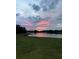Picturesque sunset with reflections on the lake against the backdrop of lush greenery at 2275 Kenya Ln, Punta Gorda, FL 33983