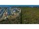 Breathtaking aerial view of waterfront homes, canals, and the stunning ocean in the distance at 24362 Yacht Club Blvd, Punta Gorda, FL 33955