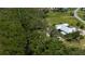 Aerial view of home backing up to canal with lush mangrove habitat and mature trees in the yard at 24362 Yacht Club Blvd, Punta Gorda, FL 33955