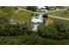 Aerial view of home in lush community featuring mature trees, canals, and beautiful waterfront views at 24362 Yacht Club Blvd, Punta Gorda, FL 33955