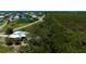 Aerial view of home, adjacent canal, and neighborhood featuring waterfront homes and lush surroundings at 24362 Yacht Club Blvd, Punta Gorda, FL 33955