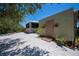 Backyard featuring lush landscaping, pea gravel, wooden shed, a screened porch and mature trees at 24362 Yacht Club Blvd, Punta Gorda, FL 33955