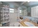 Bathroom with granite countertop, patterned shower curtain, and tiled walls at 24362 Yacht Club Blvd, Punta Gorda, FL 33955