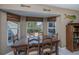 Cozy dining room with a wooden table set by the bay window providing a view at 24362 Yacht Club Blvd, Punta Gorda, FL 33955