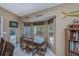 Dining room area featuring a wood table set by bay windows that offer natural light at 24362 Yacht Club Blvd, Punta Gorda, FL 33955