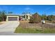 Charming single-story home with a well-maintained yard, and a paved driveway leading to a two-car garage at 24362 Yacht Club Blvd, Punta Gorda, FL 33955