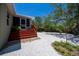 Home exterior showcasing a spacious shell driveway, a screened-in porch, and beautifully landscaped yard at 24362 Yacht Club Blvd, Punta Gorda, FL 33955