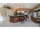 Spacious kitchen features an island with seating, stainless steel appliances, and white tiled floors at 24362 Yacht Club Blvd, Punta Gorda, FL 33955