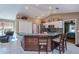 Kitchen featuring an island with seating, stainless steel appliances and white tiled floors at 24362 Yacht Club Blvd, Punta Gorda, FL 33955