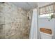 Tiled shower with glass shelf, white shower curtain, and toiletries at 24362 Yacht Club Blvd, Punta Gorda, FL 33955