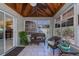 Enclosed sunroom has tile floors, wood ceiling, and lots of windows at 24362 Yacht Club Blvd, Punta Gorda, FL 33955