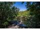 Peaceful water view surrounded by lush greenery and trees at 24362 Yacht Club Blvd, Punta Gorda, FL 33955