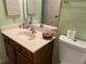 Bathroom featuring a vanity, mirror, toilet, and decorative touches at 25188 Marion Ave # F201, Punta Gorda, FL 33950