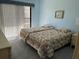 Cozy bedroom with two beds, soft carpet, and natural light, creating a peaceful and inviting space at 25188 Marion Ave # F201, Punta Gorda, FL 33950