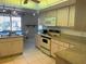 Bright kitchen features tile flooring, stainless sink, and breakfast nook at 25188 Marion Ave # F201, Punta Gorda, FL 33950