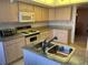 The kitchen features granite countertops, tile backsplash, and stainless sink at 25188 Marion Ave # F201, Punta Gorda, FL 33950