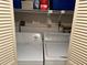 Bright laundry area with washer, dryer, and shelving for easy organization at 25188 Marion Ave # F201, Punta Gorda, FL 33950