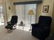 Comfortable living room with cozy seating, bathed in natural light from the window, creating an inviting atmosphere at 25188 Marion Ave # F201, Punta Gorda, FL 33950