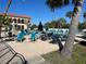 Relaxing community pool with ample seating, lounge chairs, and dining for social gatherings and outdoor enjoyment at 25188 Marion Ave # F201, Punta Gorda, FL 33950