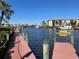 Waterfront view with a dock, canal, boats, and building in the background at 25188 Marion Ave # F201, Punta Gorda, FL 33950