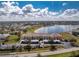 An aerial view of condos and covered parking near a lake with blue sky and scattered clouds at 26397 Nadir Rd # 208, Punta Gorda, FL 33983