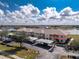 Aerial view of condos with covered parking spaces and balconies overlooking a scenic lake at 26397 Nadir Rd # 208, Punta Gorda, FL 33983