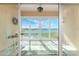 Balcony with sliding glass doors, offering stunning waterfront views and a tranquil seating area at 26397 Nadir Rd # 208, Punta Gorda, FL 33983